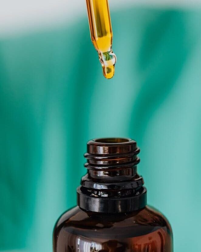 Brown glass bottle with liquid and pipette